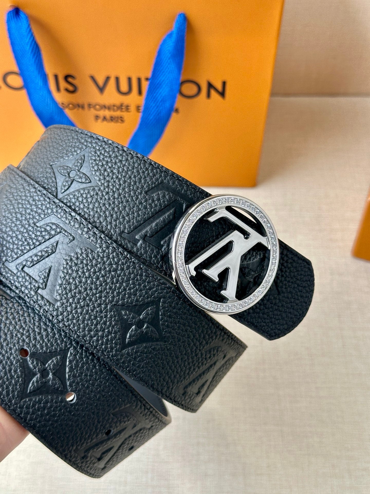Louis Vuitton dark leather belt end with eyelets and silver logo buckle on monogram strap