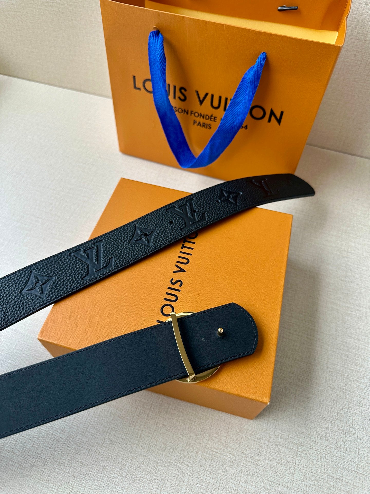 Louis Vuitton dark leather belt with monogram emboss and adjustable metal buckle clasp