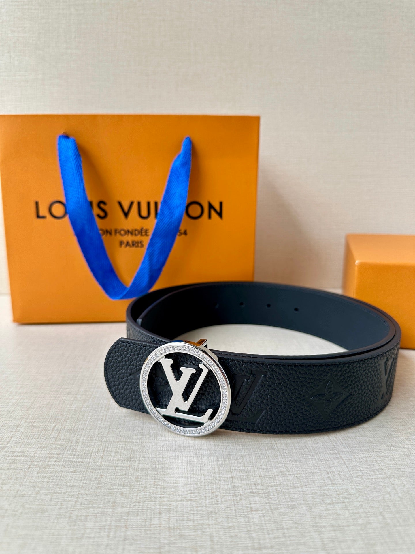 Louis Vuitton dark leather belt with silver logo buckle, monogram textured strap