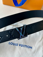 Louis Vuitton belt close-up: dark patterned leather strap with LV square buckle