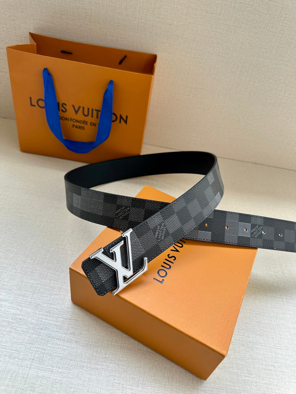Dark gray check belt with silver LV buckle and stitched leather keeper