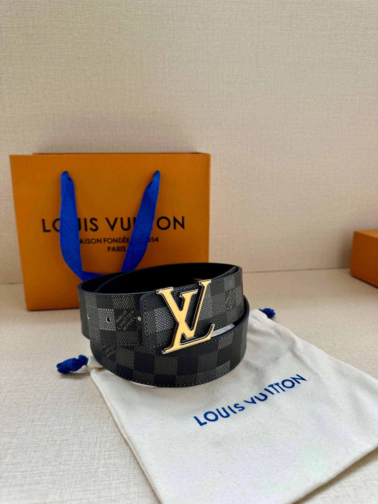 Louis Vuitton Damier belt with gold LV buckle on dark strap