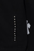 Black shirt front placket detail with vertical row of silver studs