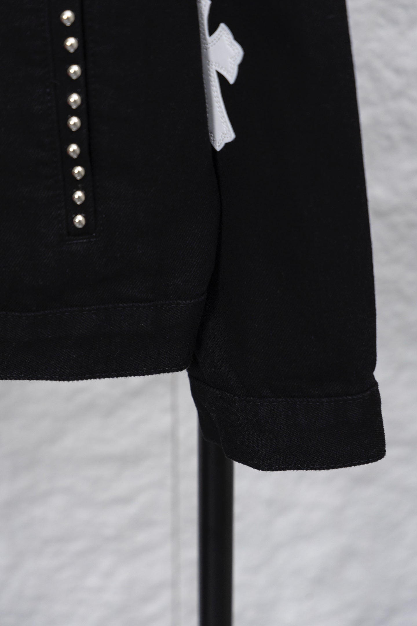Black long-sleeve jacket sleeve cuff with stitched hem detail