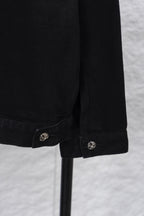 Black denim shirt sleeve cuff with round emblem snap button