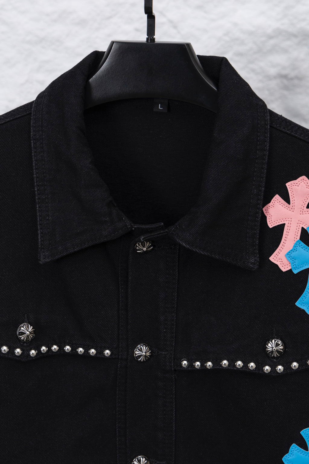 Black denim shirt collar and placket with studded trim and small emblem