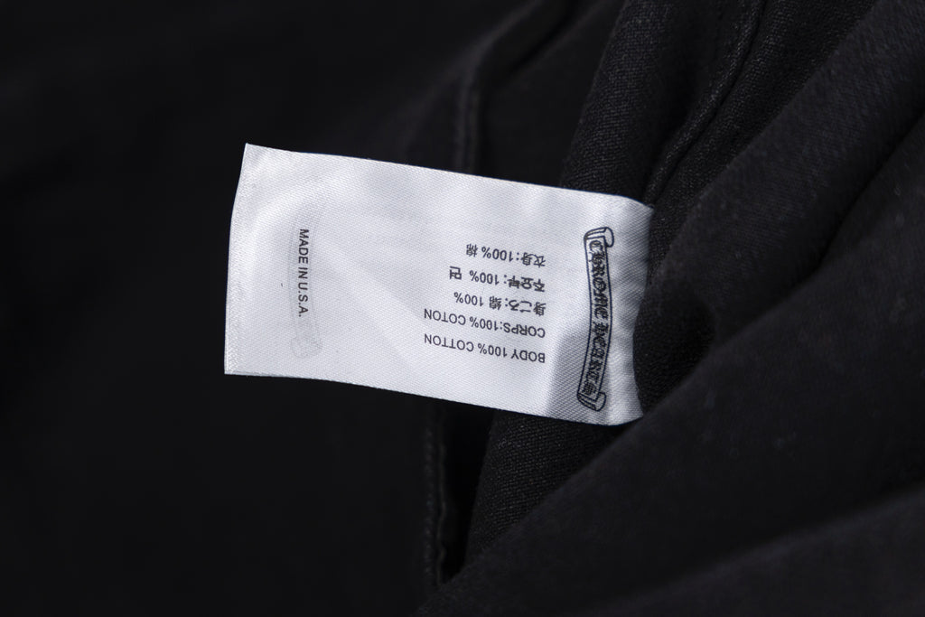 Black garment with white size label on inside seam