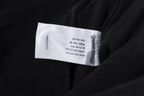 Black garment with white size label on inside seam