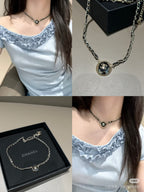 Gold chain necklace with round CC pendant and small Chanel charm