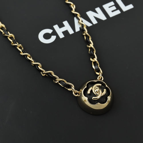 Gold chain necklace with round black-and-gold CC pendant and interlocking links