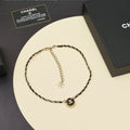 Gold chain necklace with CC logo round pendant and interlocking chain links
