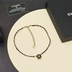 Gold chain necklace with CC logo round pendant and interlocking chain links