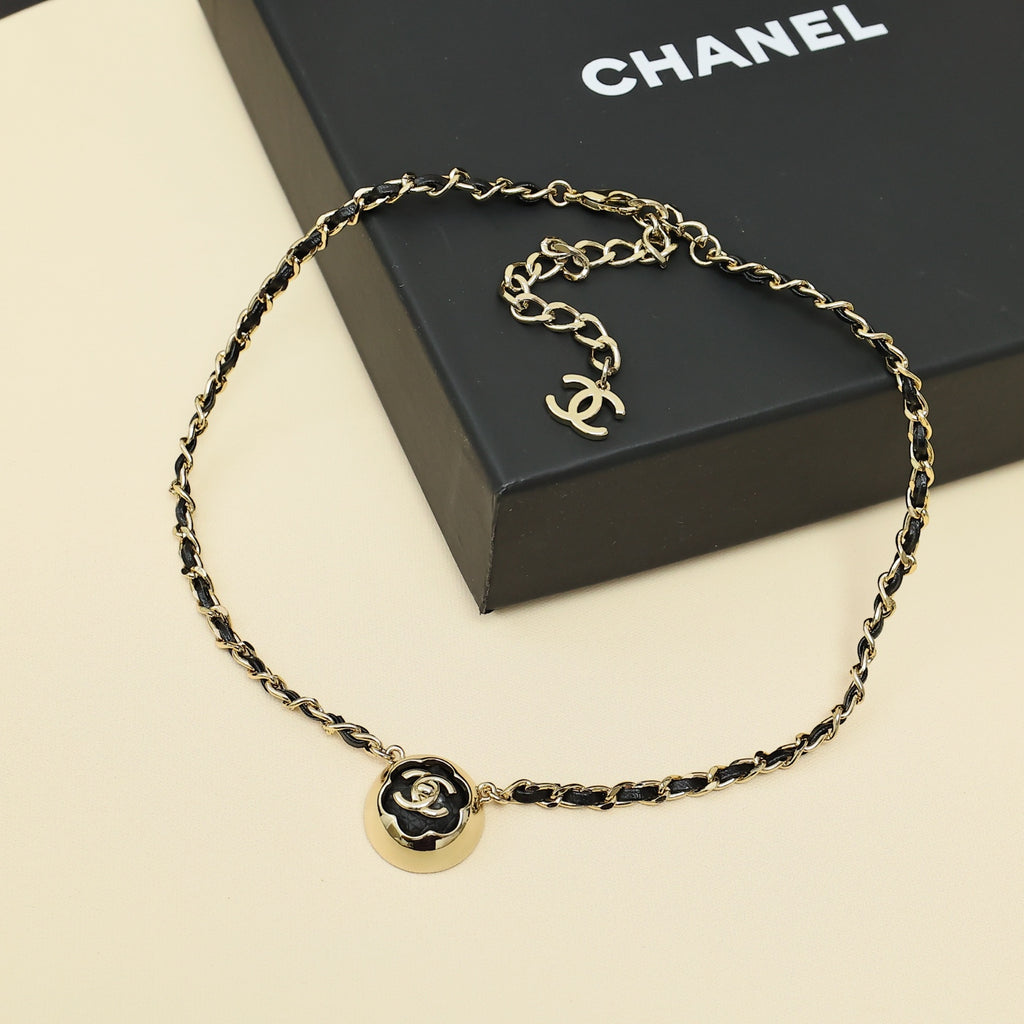 Gold chain necklace with round CC pendant charm centered on the chain