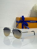 Louis Vuitton sunglasses with silver frames and dark gradient lenses, black temple tips.