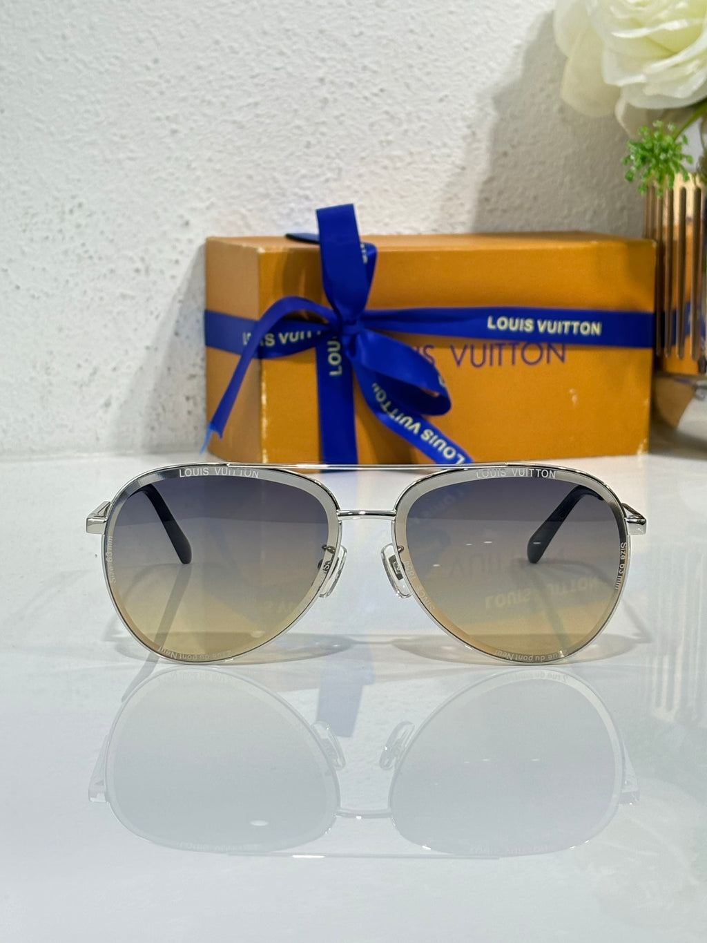 Sunglasses with silver round frames, dark gradient lenses, and black accents on temples.