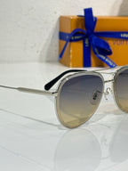 Sunglasses in silver with dark gradient lens and black nose pad, side view.