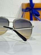 Sunglasses with silver rounded frames and dark gradient lenses, angled front view.