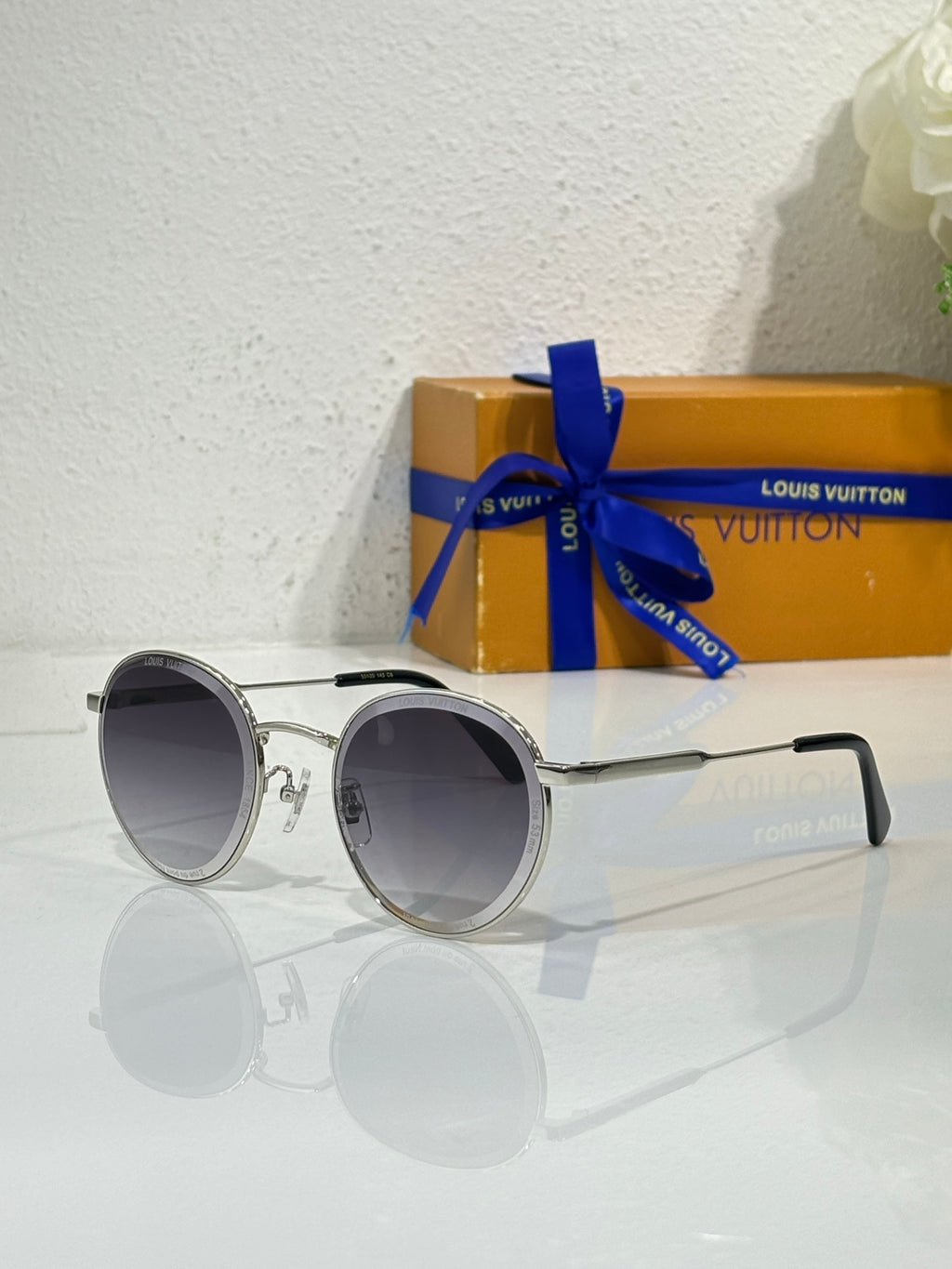 Louis Vuitton round sunglasses, silver metal frame, dark lenses with curved arms