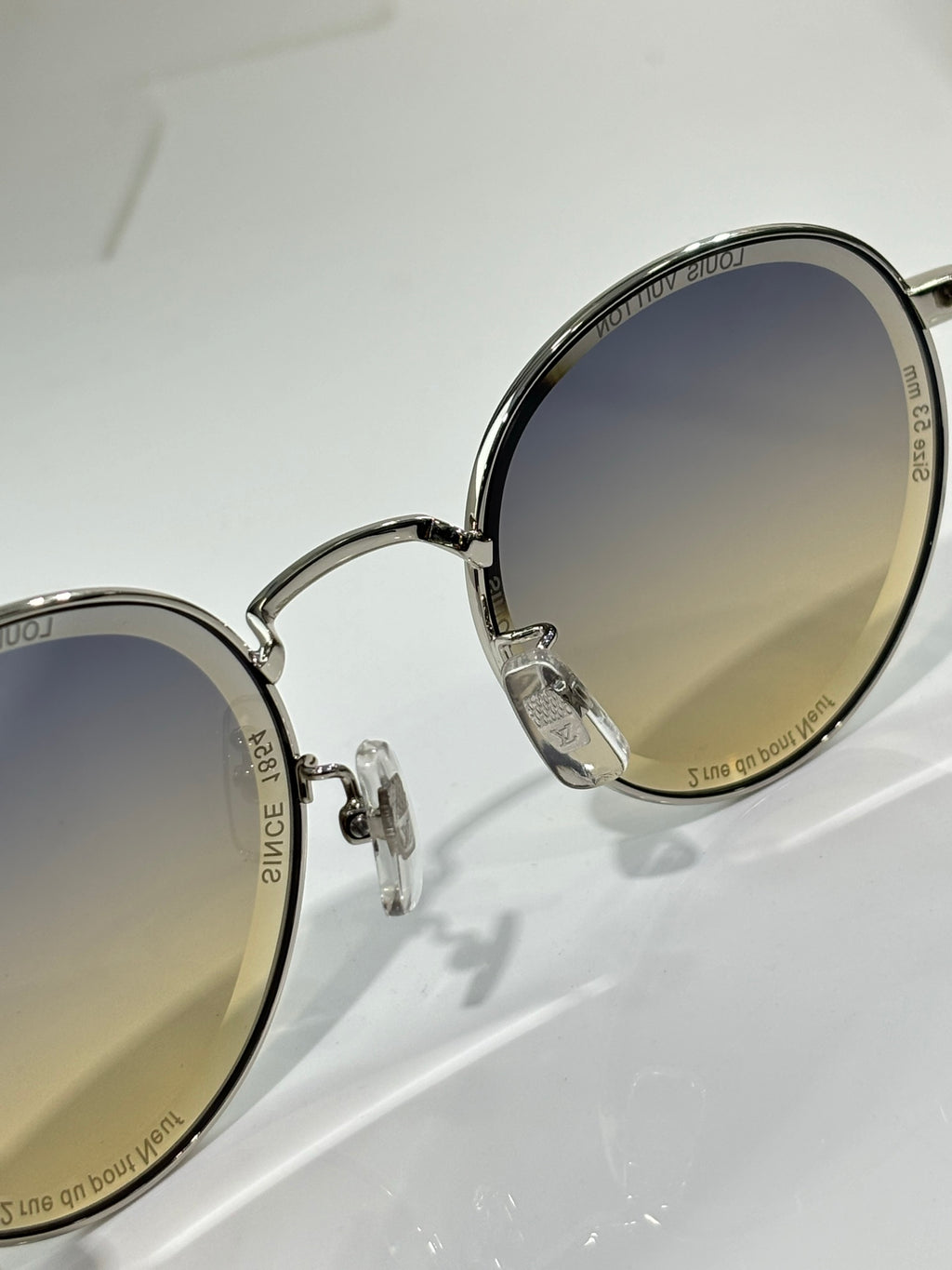 Louis Vuitton round sunglasses, close-up of hinges and lenses with dark gradient tint