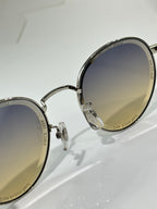 Louis Vuitton round sunglasses, close-up of hinges and lenses with dark gradient tint