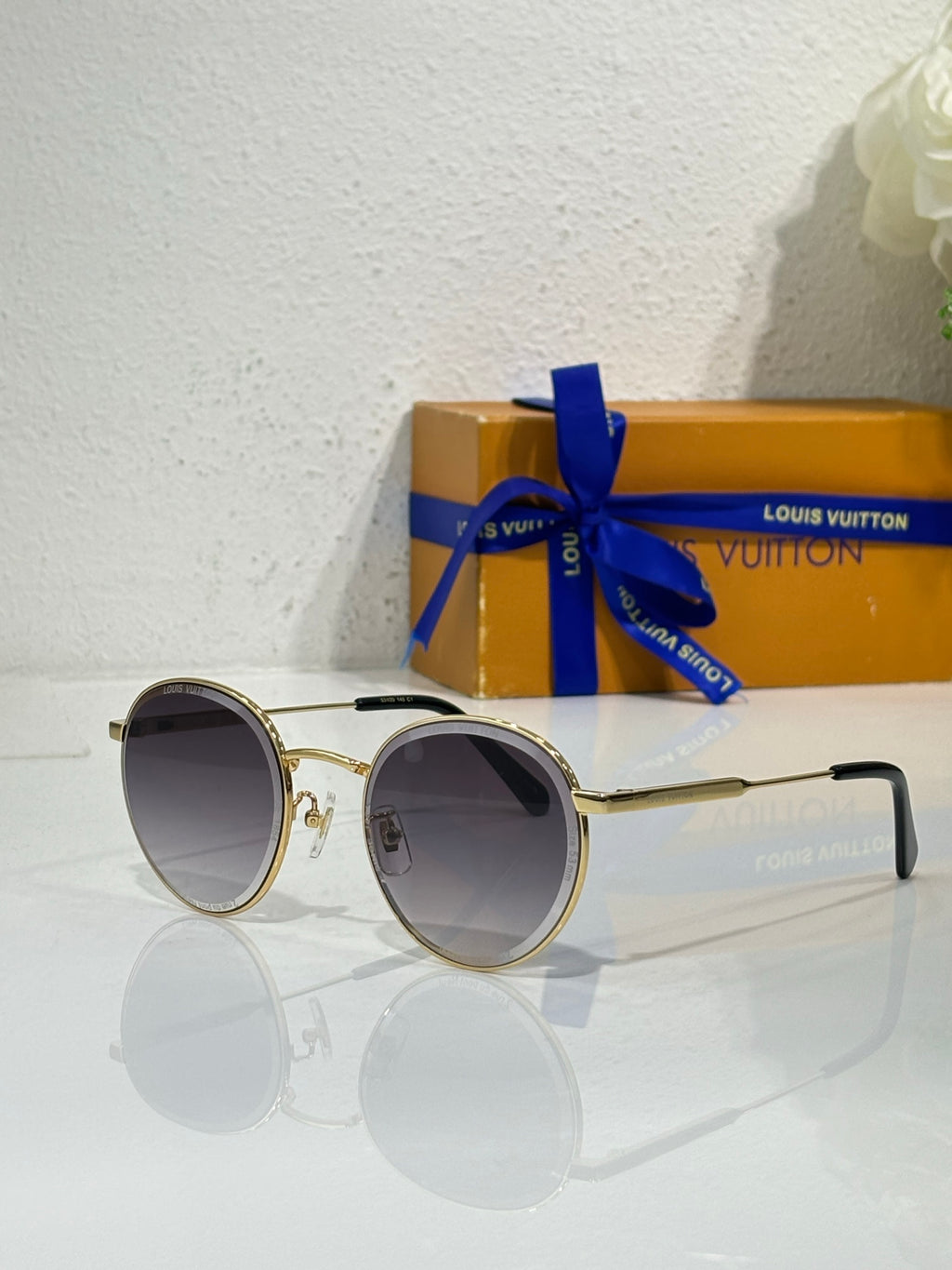 Gold-tone round sunglasses with dark lenses and slim metal frames