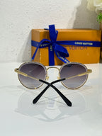 Gold-tone round sunglasses with dark lenses and black-tipped temple arms