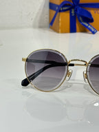 Gold-tone round sunglasses with dark lenses and black temple tips