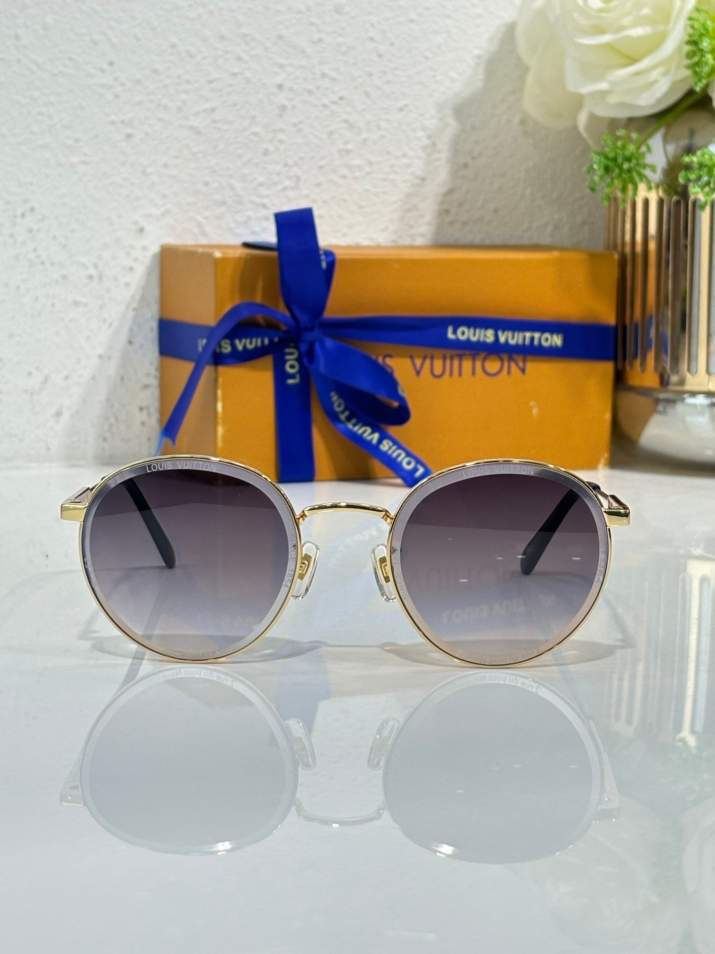 Gold-tone round sunglasses with dark gradient lenses and metal bridge detail