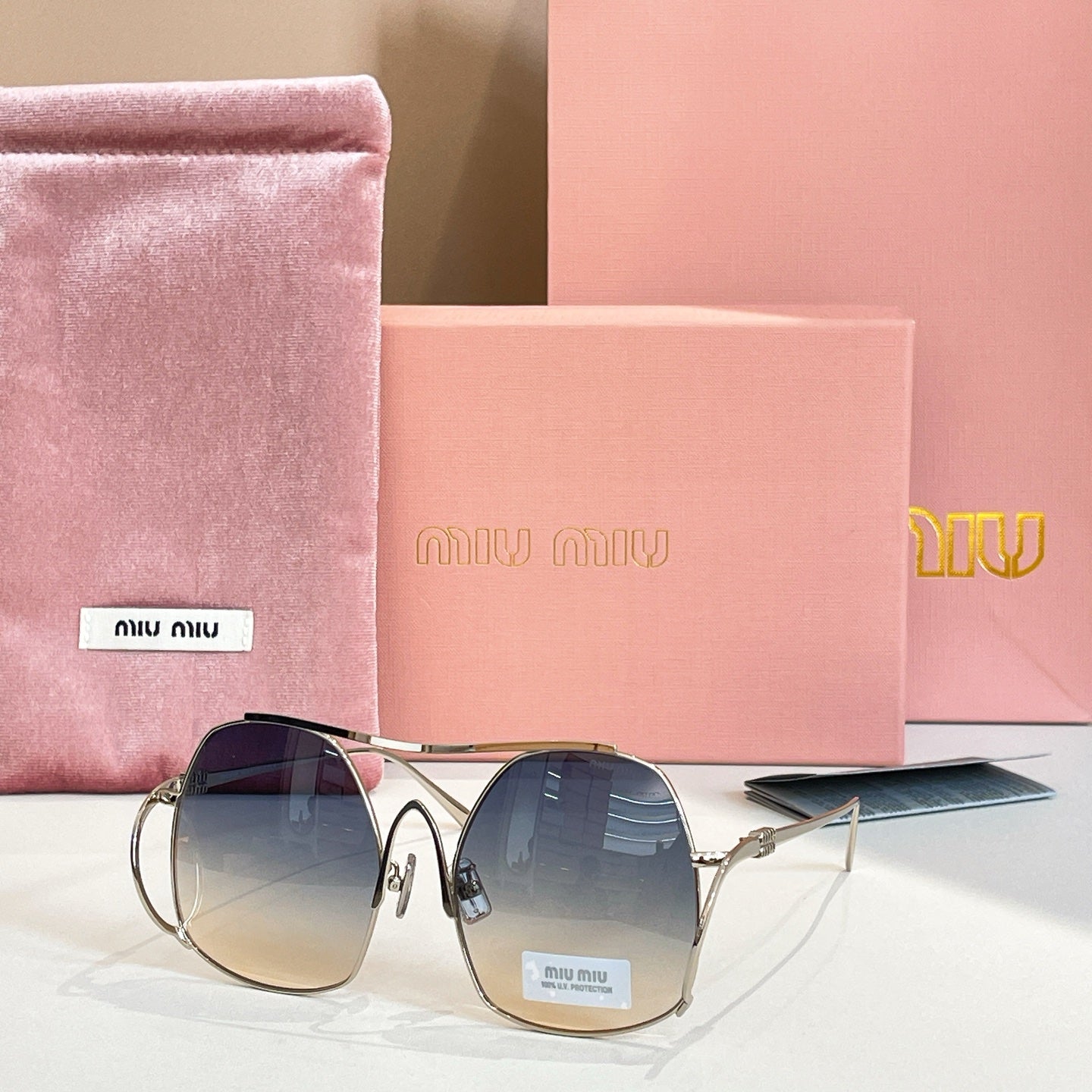 MiuMiu gold-tone sunglasses with deep blue tinted round lenses