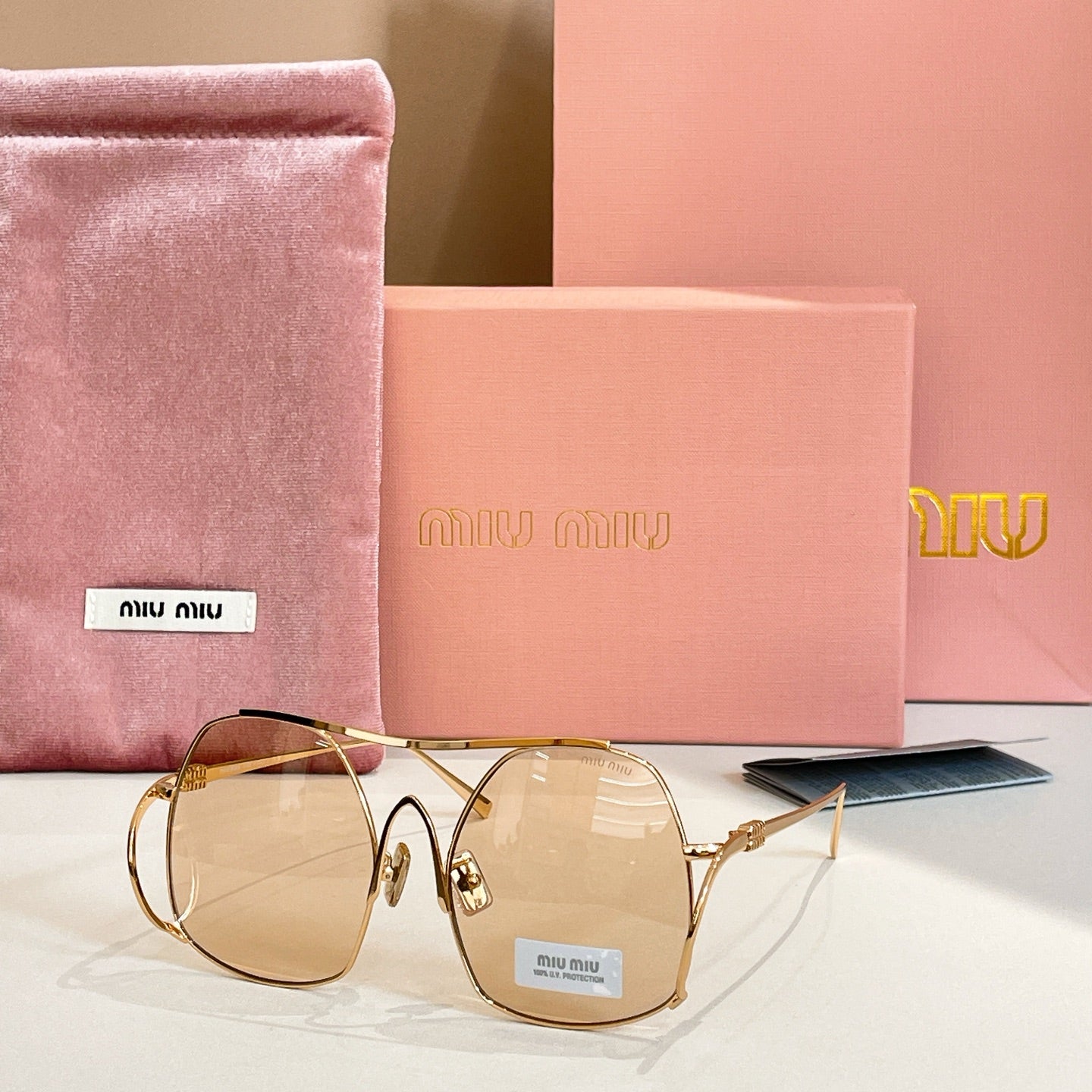 MiuMiu gold-tone sunglasses with light amber tinted round lenses