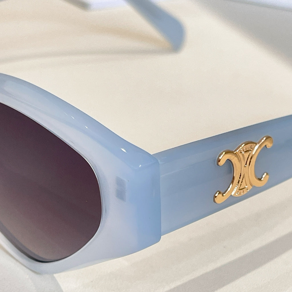 Light blue cat-eye sunglasses temple with gold logo detail