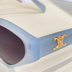 Light blue cat-eye sunglasses temple with gold logo detail