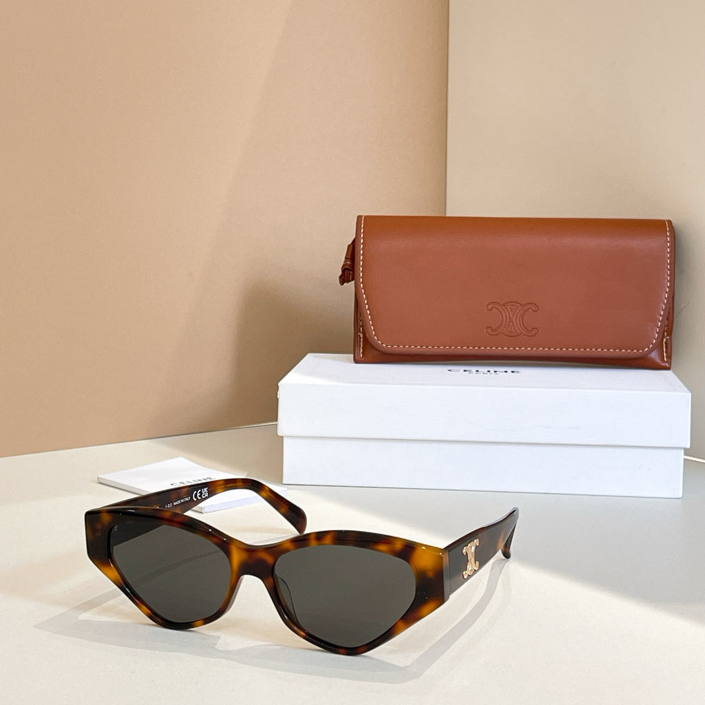 Tortoiseshell cat-eye sunglasses with dark lenses and gold logo on temples
