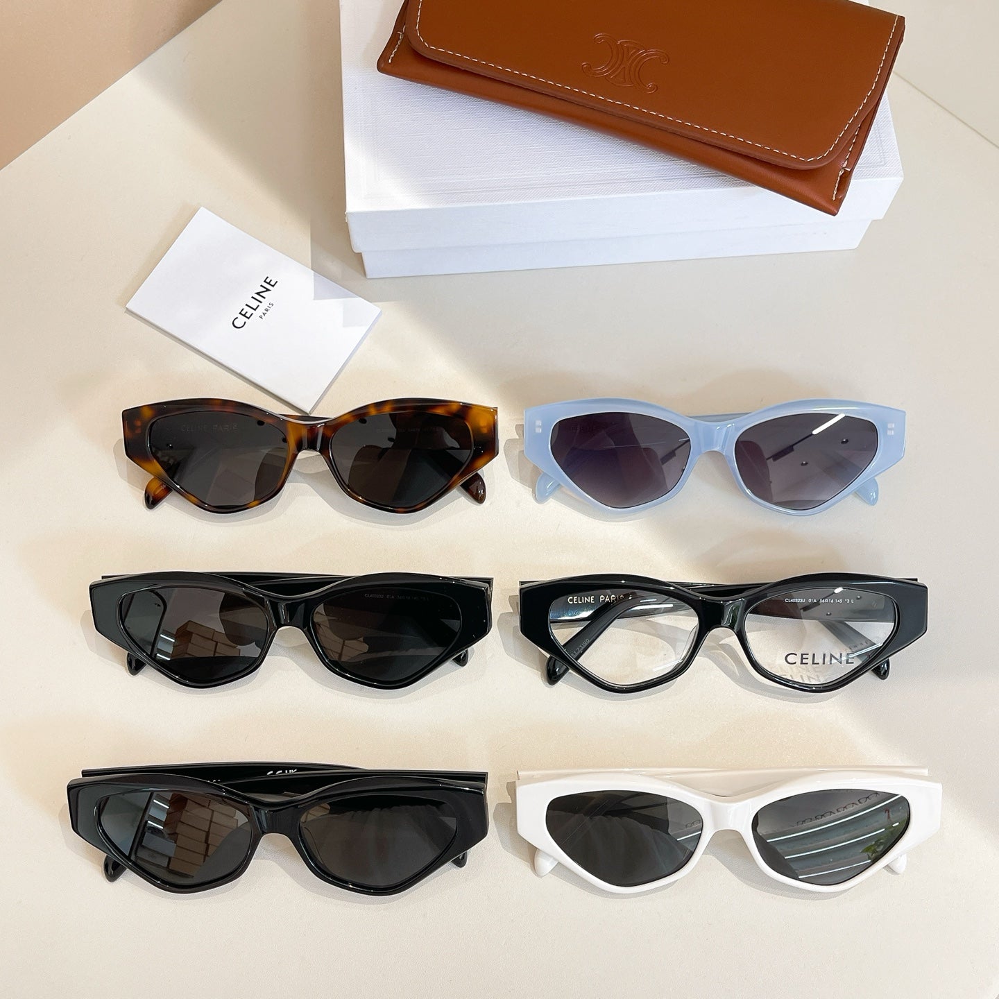 Assorted cat-eye glasses with mixed frames and dark lenses on display