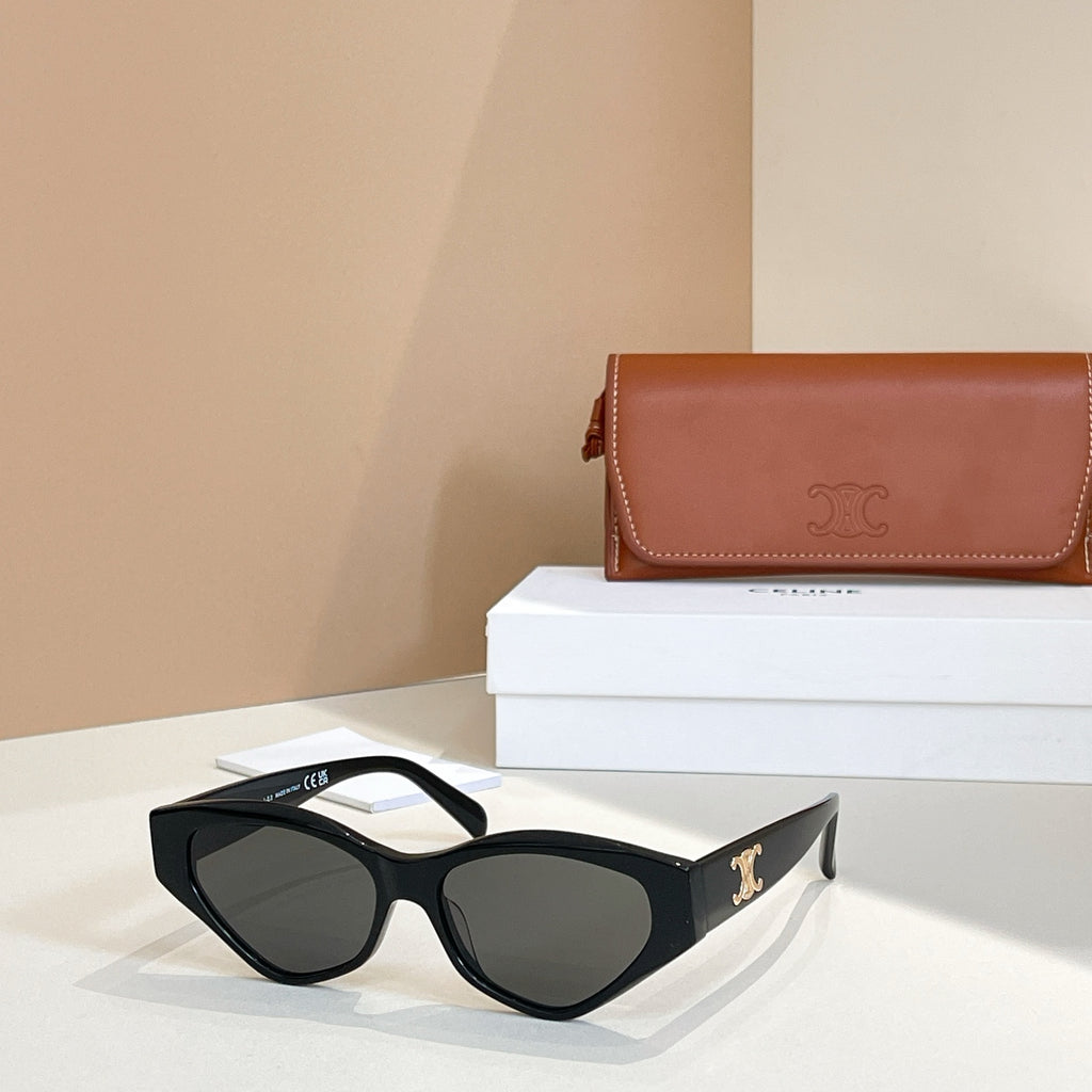 Black cat-eye sunglasses with dark lenses on a gold logo temple