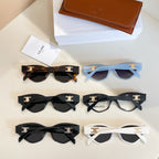 Assorted cat-eye glasses with black, white, and tortoiseshell frames