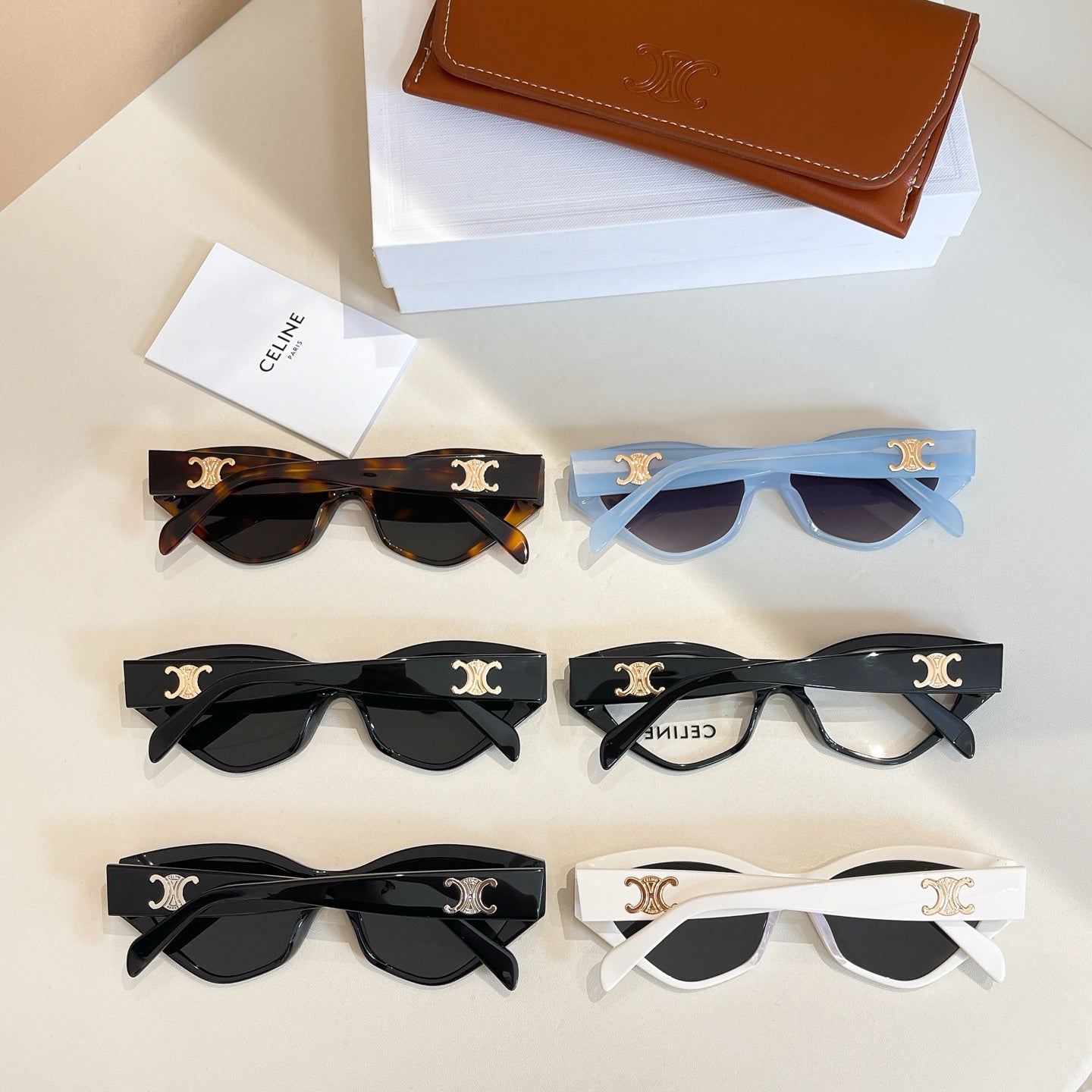 Assorted cat-eye glasses with black, white, and tortoiseshell frames