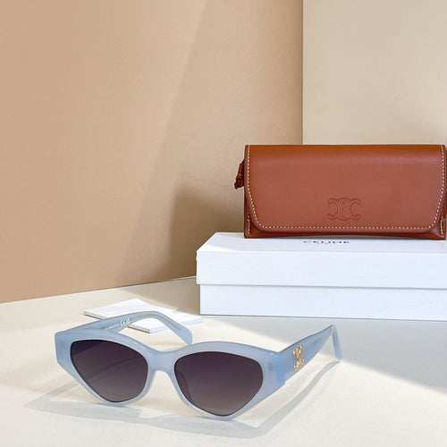 Light blue cat-eye sunglasses with dark lenses and gold logo on temples