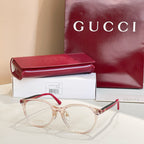 Gucci eyeglasses with light rose-gold frames and red temple tips, clear lenses