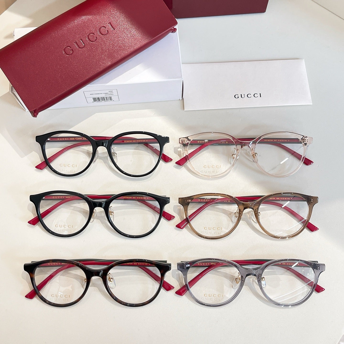 Gucci eyeglasses assortment of three pairs with red temple accents and clear lenses