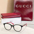 Gucci eyeglasses with black frames and red temple tips, clear round lenses
