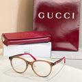 Gucci eyeglasses with tortoiseshell frames and red temple tips, clear lenses