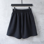 Balenciaga shorts with elastic waistband and small red logo on the front