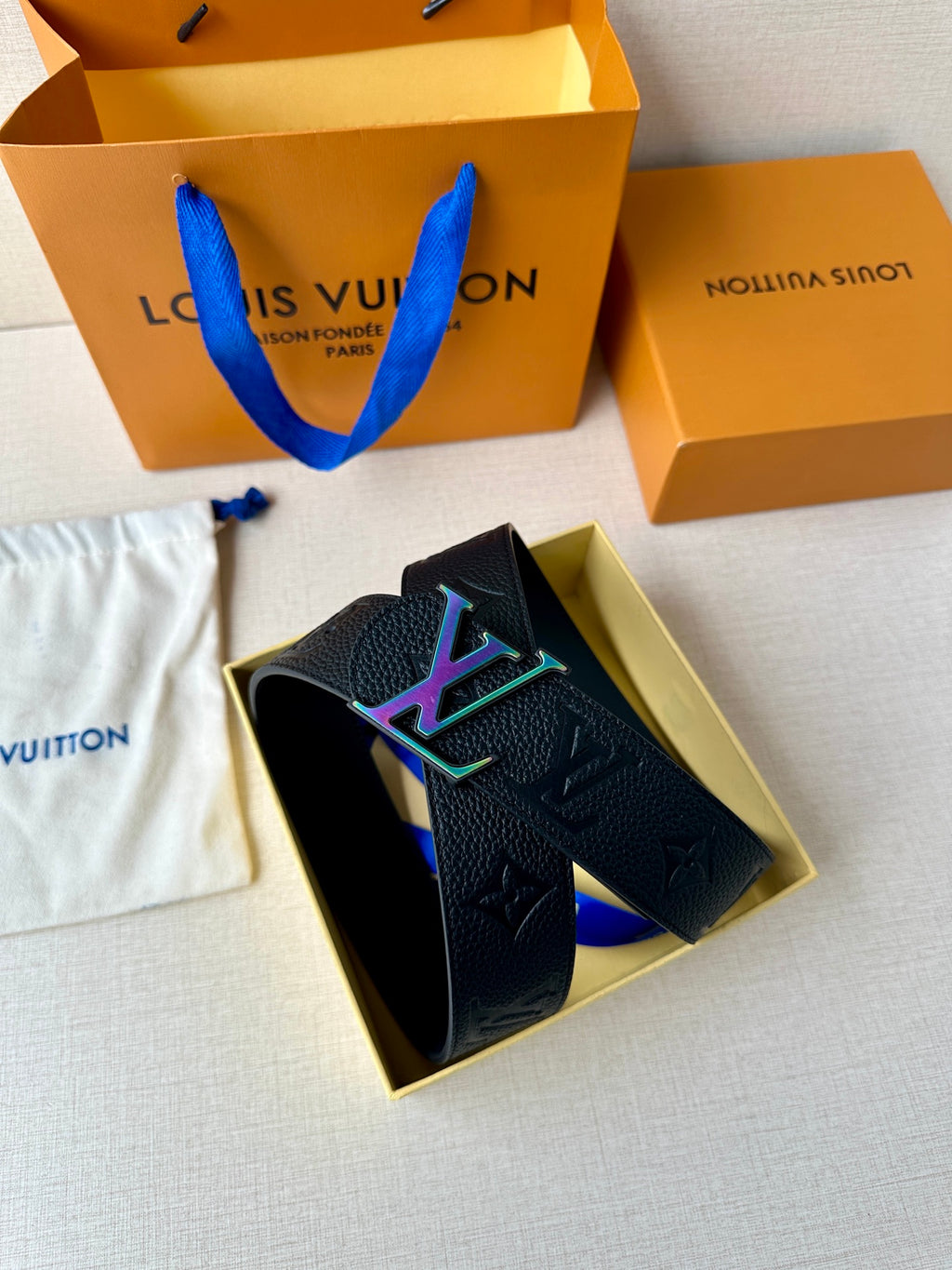 Textured dark leather belt with LV monogram and multicolor buckle in open gift box