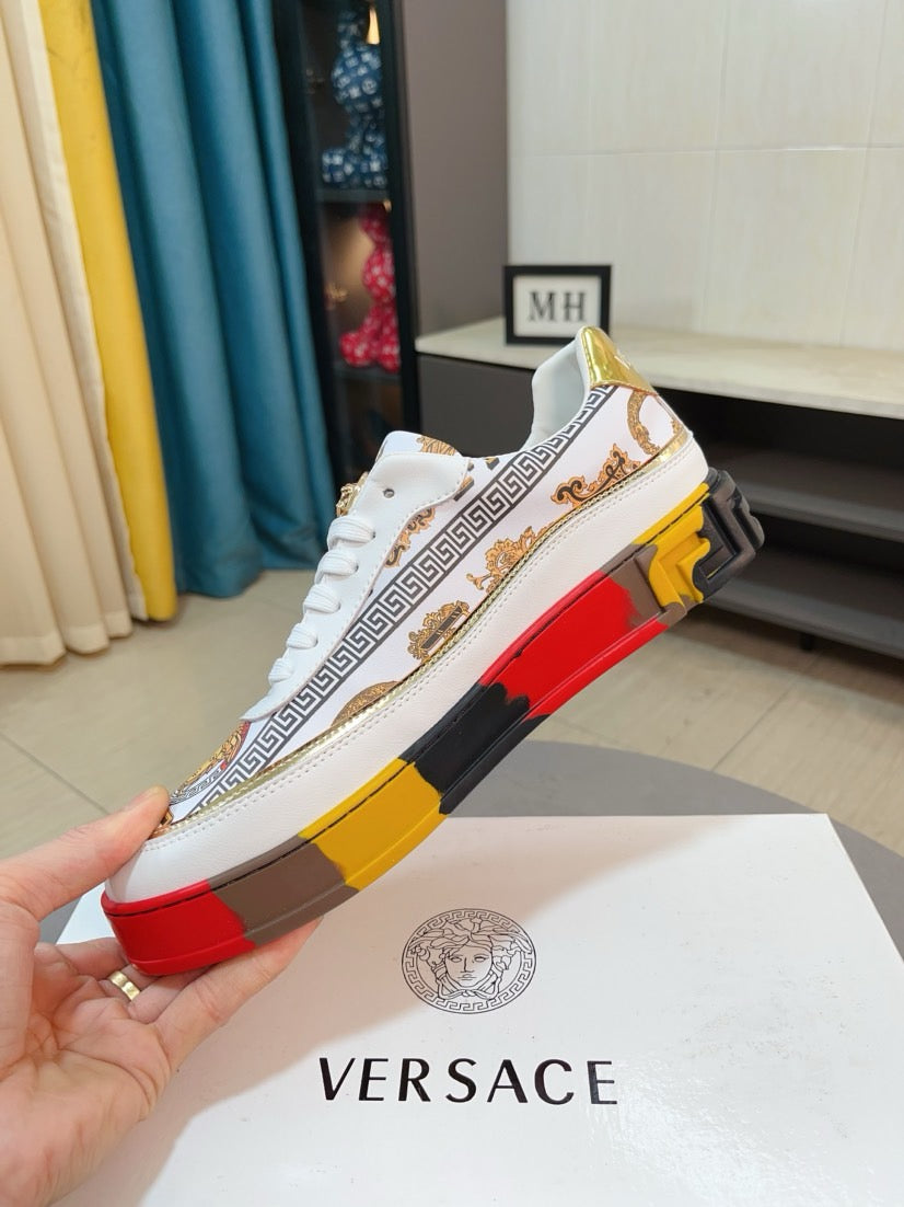 Versace luxury sneakers, white upper with Greek stripe; red, black, yellow outsole.
