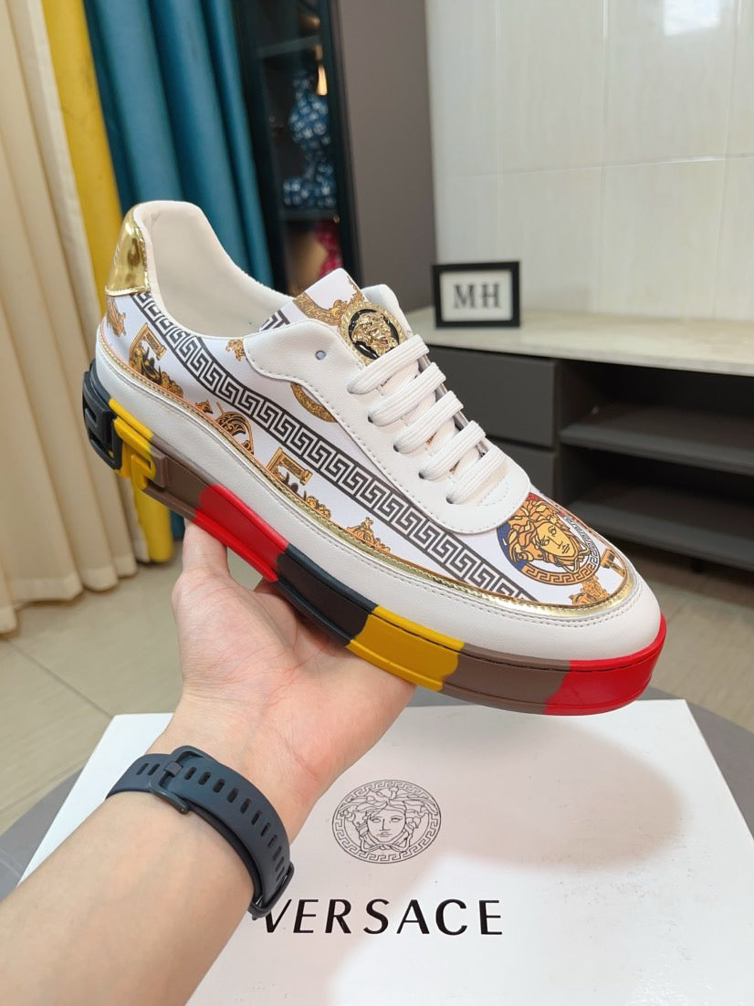 Versace luxury sneakers, white upper with Greek pattern stripe and gold crest detail.