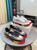 Versace luxury sneakers set: white with gold crest print, black with logo trim.