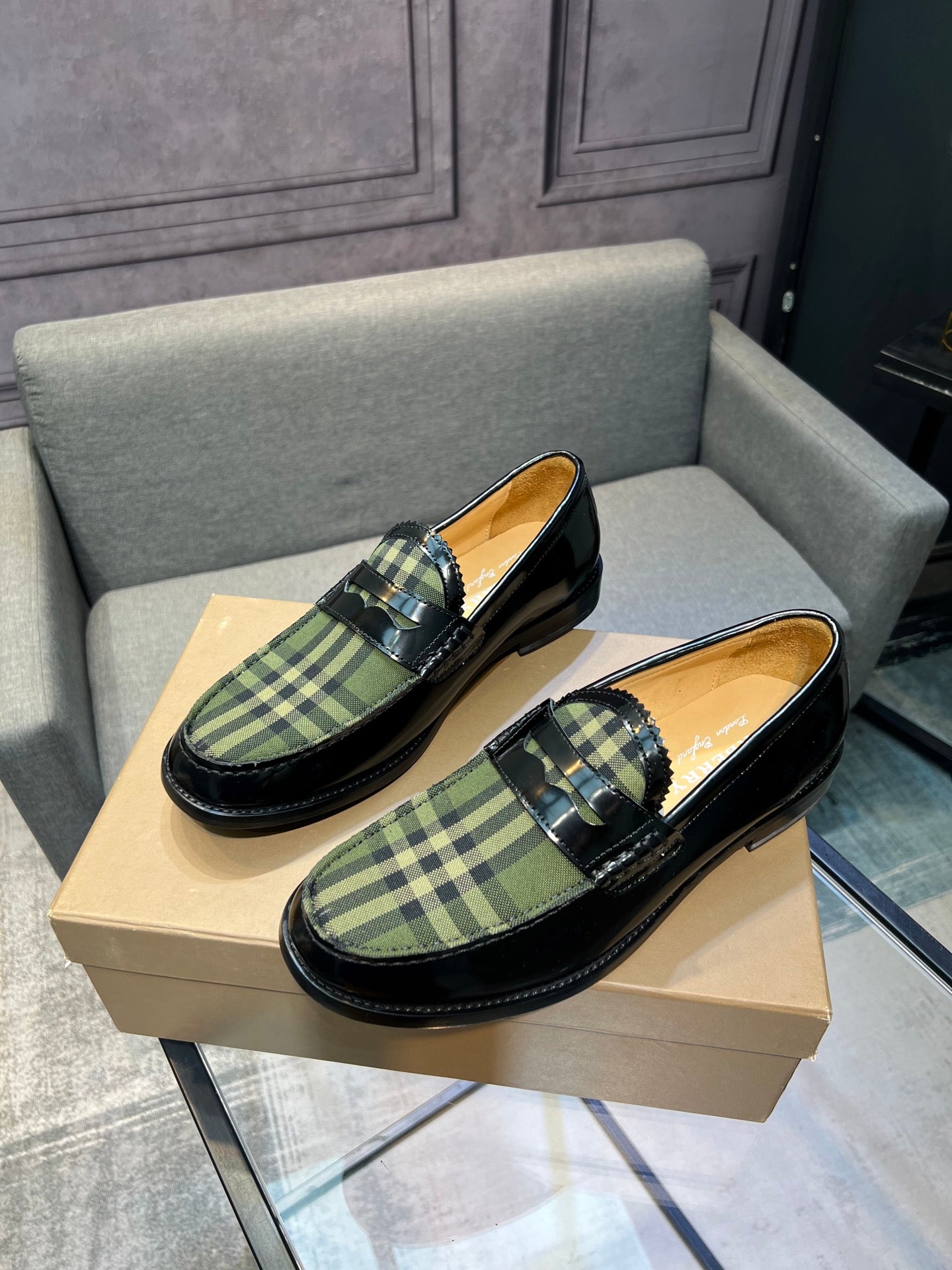 Burberry plaid loafers on beige box, black leather with green tartan slip-on style
