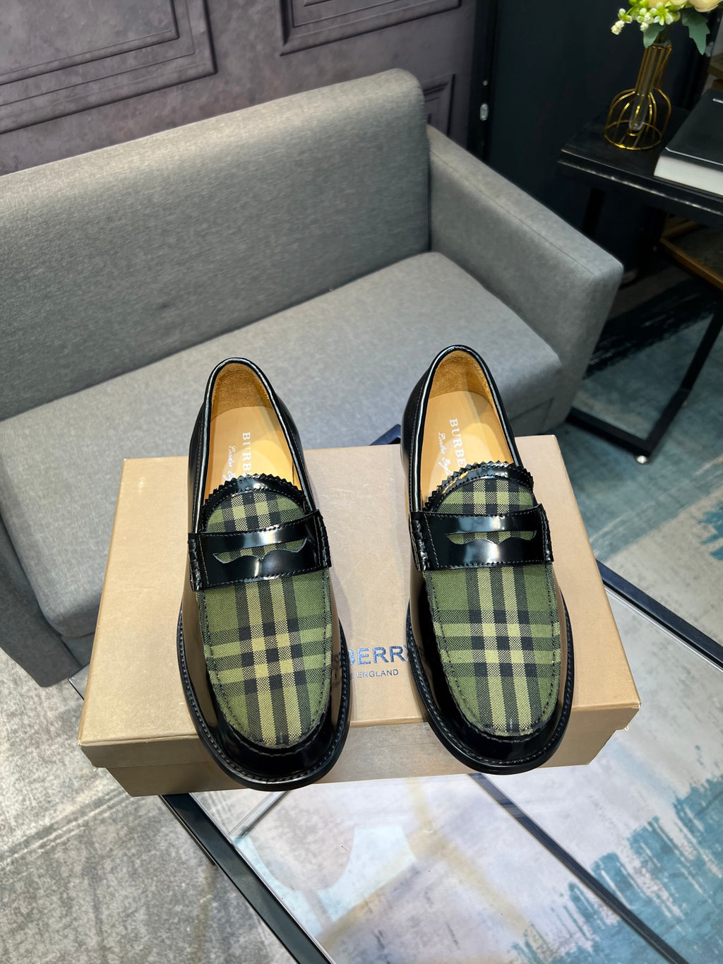 Burberry plaid loafers, front view; black leather with green tartan vamp and strap