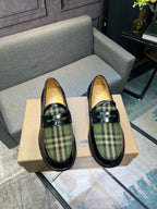 Burberry plaid loafers, front view; black leather with green tartan vamp and strap